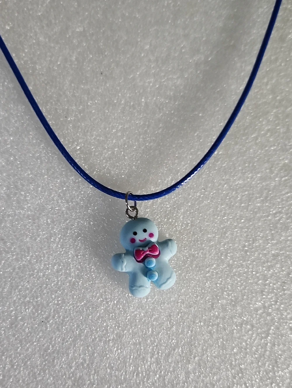 Hand Crafted Blue Gingerbread Man Necklace with Pink Bow
